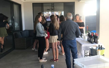 Guests with drinks on a covered patio at a private event catered by Made In Italy